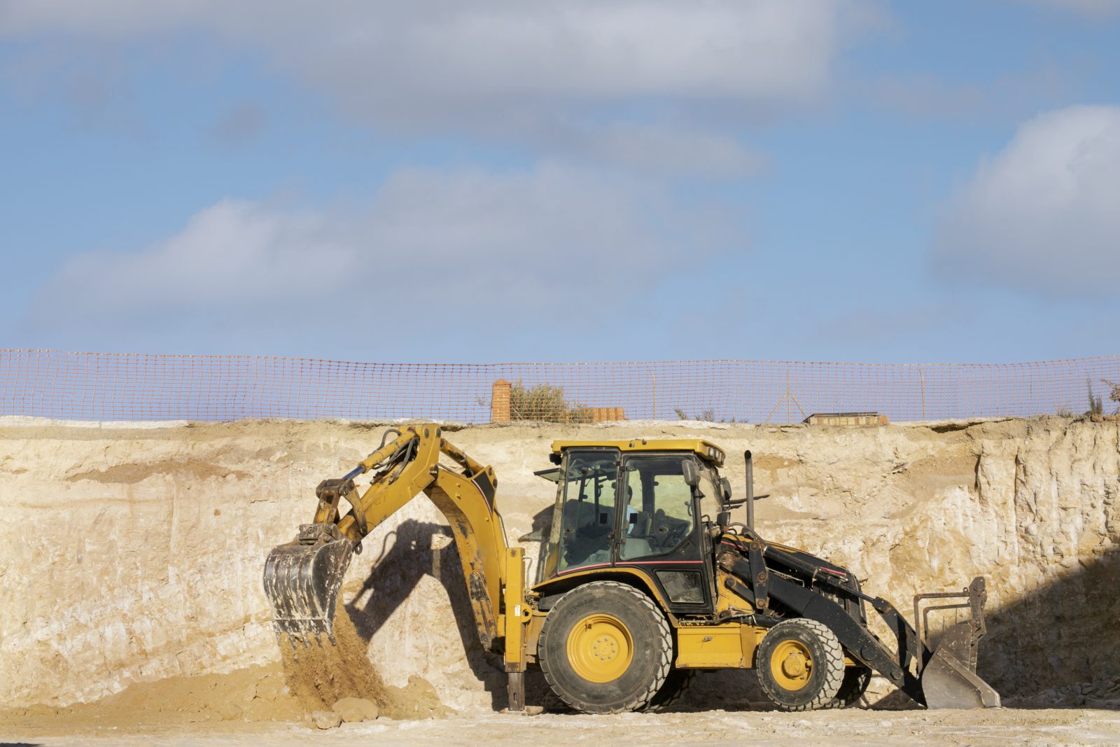 excavator digging ground day light